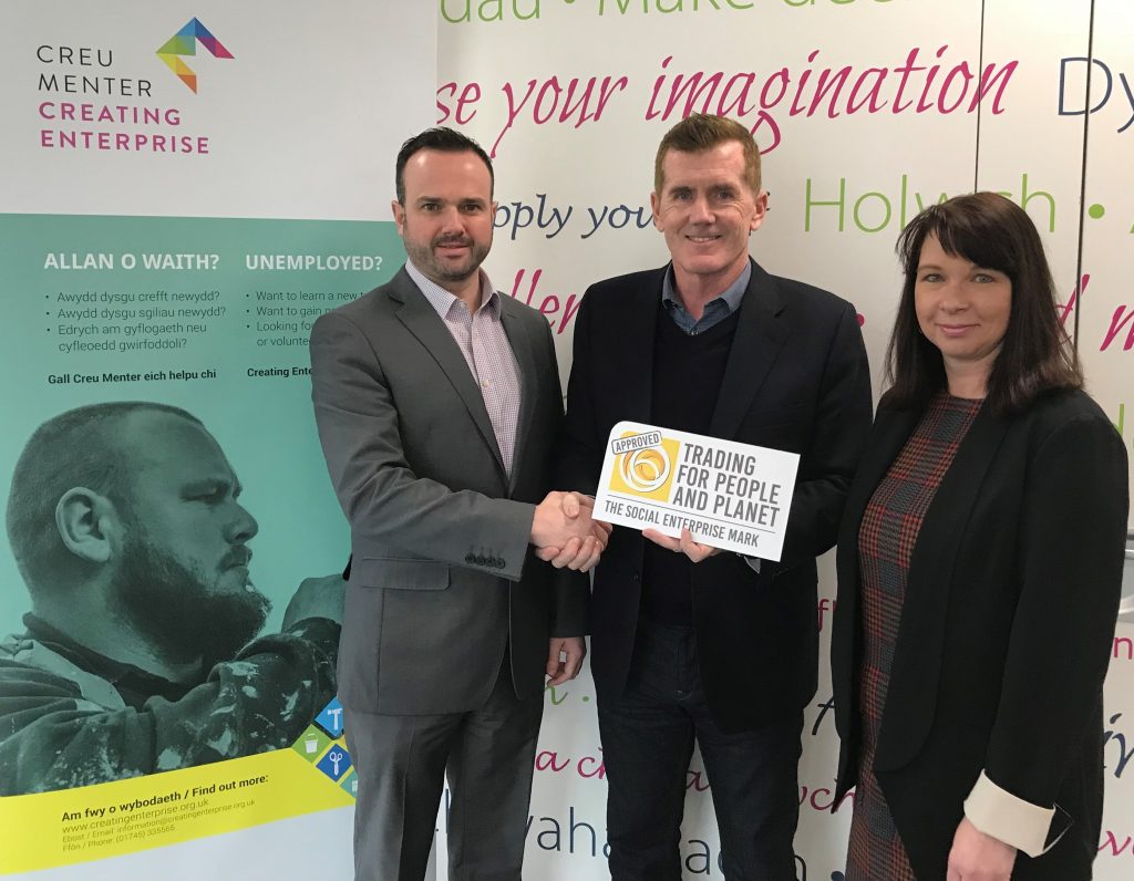 Creating Enterprise’s Chairman Peter Parry (centre) presents the Social Enterprise Mark to Adrian Johnson, MD (l) and Sharon Jones, Director (r)
